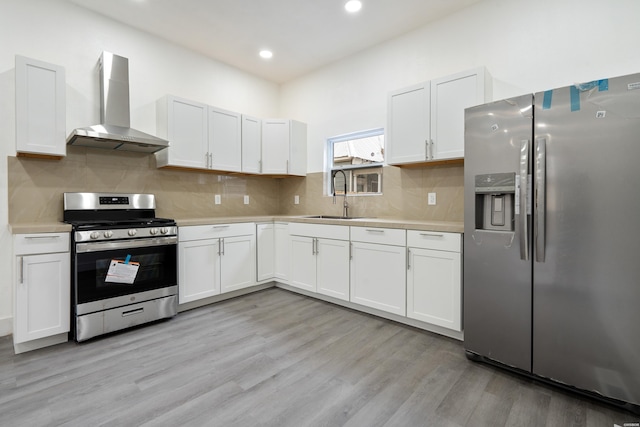207 Hagen St, Hot Springs, AR 71913 - kitchen featuring wall chimney exhaust hood, a sink, appliances with stainless steel finishes, and light countertops