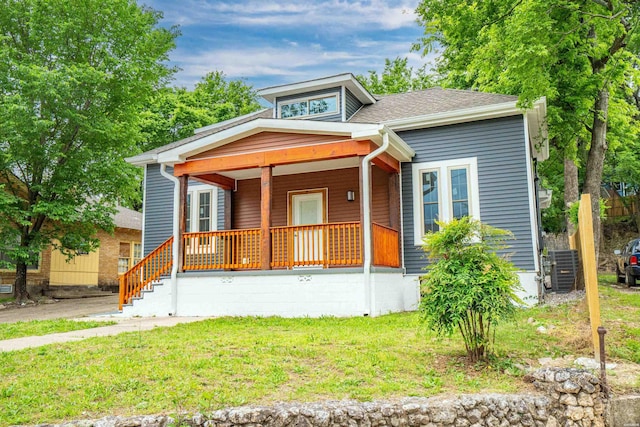 207 Hagen St, Hot Springs, AR 71913 - bungalow-style home with a front yard, central AC, covered porch, and roof with shingles