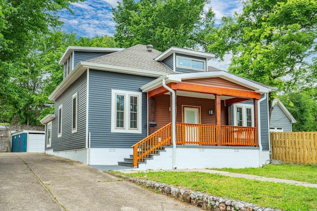 207 Hagen St, Hot Springs, AR 71913 - bungalow-style home with a garage, a shingled roof, an outbuilding, covered porch, and fence