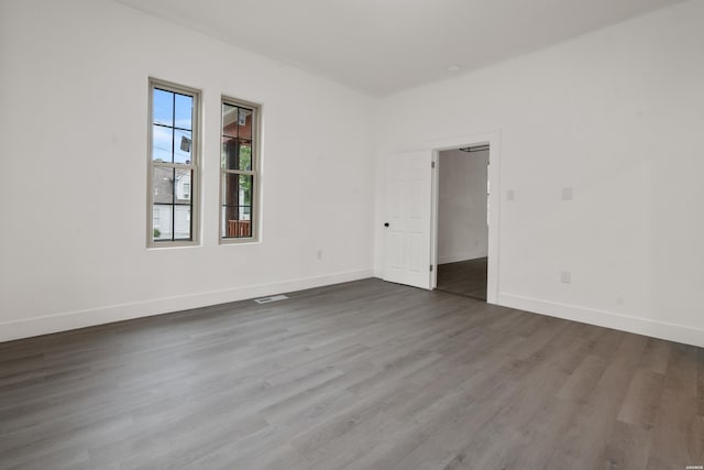 207 Hagen St, Hot Springs, AR 71913 - empty room featuring baseboards, visible vents, and dark wood-type flooring