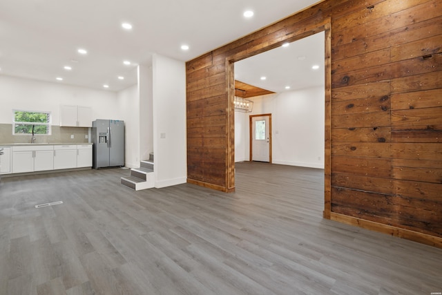 207 Hagen St, Hot Springs, AR 71913 - unfurnished living room with baseboards, recessed lighting, stairway, and a sink