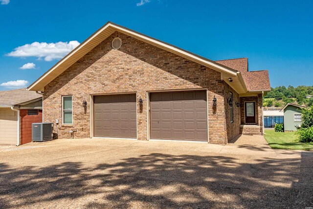 220 Mcdonald Loop, Hot Springs, AR 71913 - view of front of home featuring driveway, a garage, roof with shingles, and brick siding