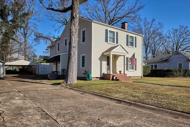 view of front facade with crawl space, a chimney, concrete driveway, and a front yard