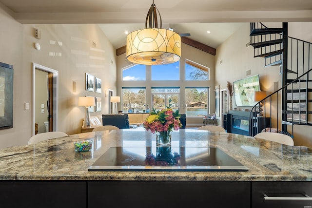 kitchen featuring high vaulted ceiling, black electric cooktop, beam ceiling, stone countertops, and open floor plan