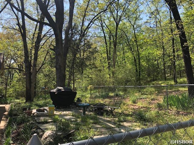 view of yard featuring fence and a view of trees