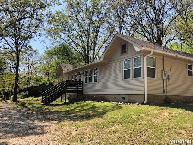 view of side of home with a lawn