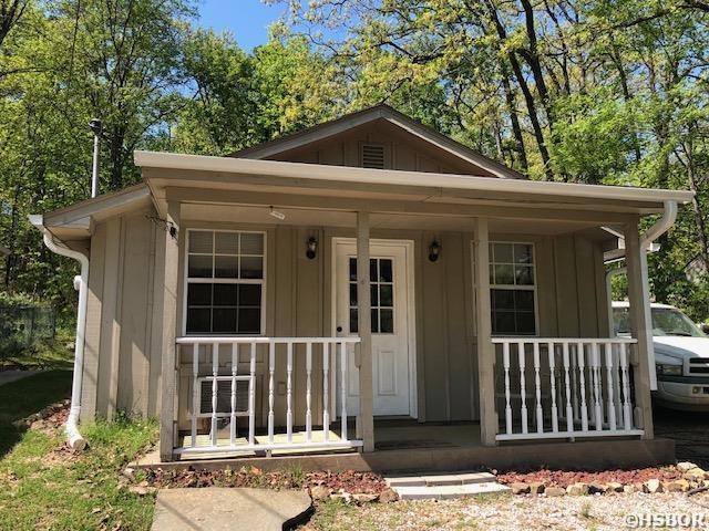 exterior space featuring board and batten siding and covered porch