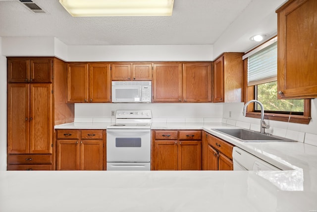 724 Weston Rd Unit Q-4, Hot Springs, AR 71913 - kitchen featuring white appliances, light countertops, brown cabinets, and a textured ceiling