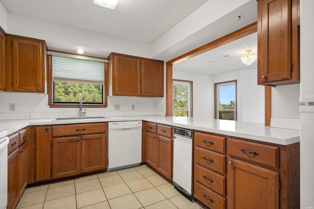 724 Weston Rd Unit Q-4, Hot Springs, AR 71913 - kitchen with white dishwasher, brown cabinetry, light tile patterned floors, and a textured ceiling