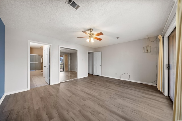 724 Weston Rd Unit Q-4, Hot Springs, AR 71913 - unfurnished bedroom with wood finished floors, a textured ceiling, connected bathroom, and a ceiling fan