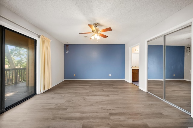 724 Weston Rd Unit Q-4, Hot Springs, AR 71913 - unfurnished bedroom featuring access to exterior, a textured ceiling, wood finished floors, a ceiling fan, and ensuite bathroom