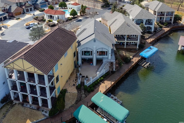 birds eye view of property with a residential view and a water view