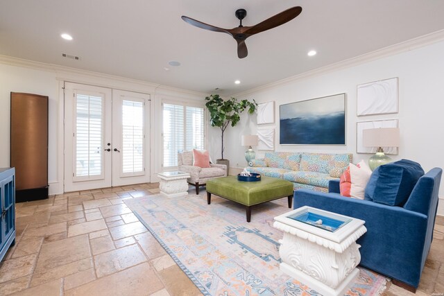 living room featuring visible vents, ceiling fan, stone tile flooring, and crown molding