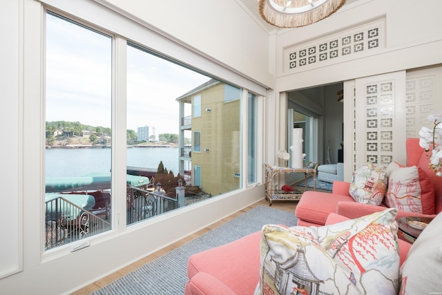 sunroom / solarium featuring a water view