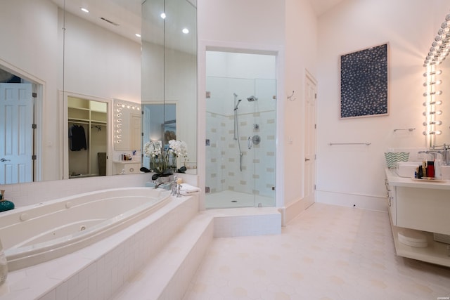 full bath with a shower stall, visible vents, a jetted tub, vanity, and a high ceiling