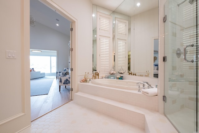 full bathroom featuring tile patterned floors, a shower stall, ensuite bath, and a garden tub