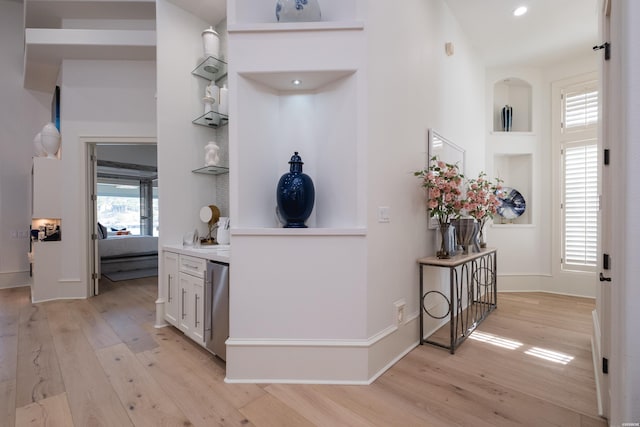 corridor featuring recessed lighting, light wood-style flooring, and baseboards