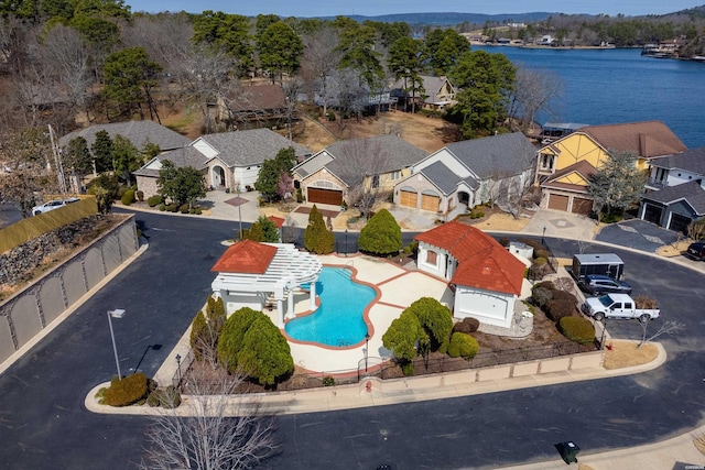 drone / aerial view featuring a residential view and a water view