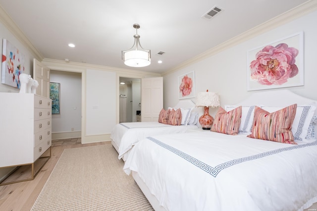 bedroom with visible vents, light wood-style floors, and crown molding