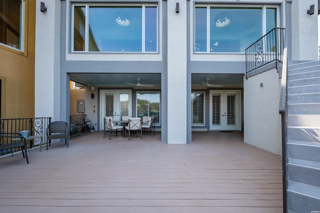 wooden deck with stairs, outdoor dining area, and french doors