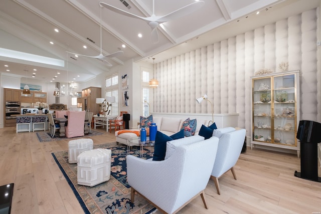 living room featuring beam ceiling, high vaulted ceiling, light wood-type flooring, a ceiling fan, and visible vents