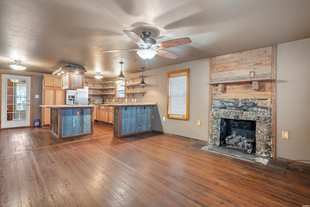 kitchen with a center island, open shelves, dark wood-type flooring, open floor plan, and stainless steel fridge with ice dispenser