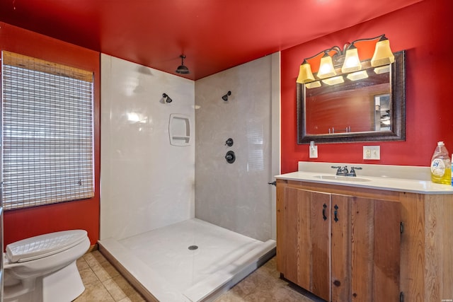 bathroom with toilet, walk in shower, vanity, and tile patterned floors
