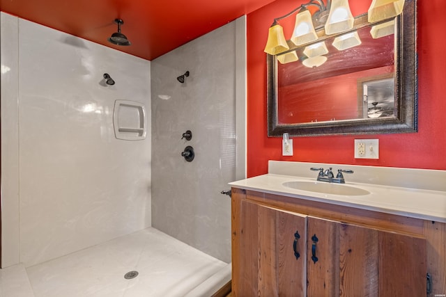 bathroom with a shower stall and vanity