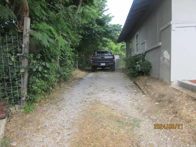 310 Hawthorne St Unit 1, 2, 3, 4, 5, Hot Springs, AR 71901 - view of side of property with gravel driveway and stucco siding