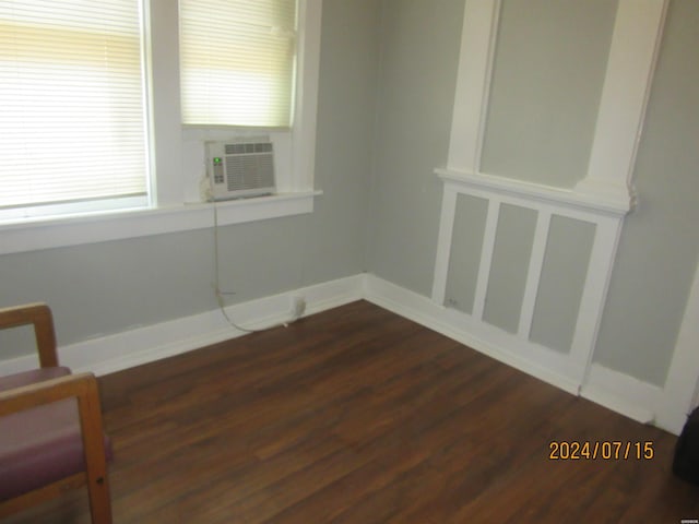 spare room with dark wood-style floors, cooling unit, and baseboards