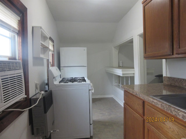 310 Hawthorne St Unit 1, 2, 3, 4, 5, Hot Springs, AR 71901 - kitchen featuring dark countertops, white appliances, vaulted ceiling, and brown cabinets