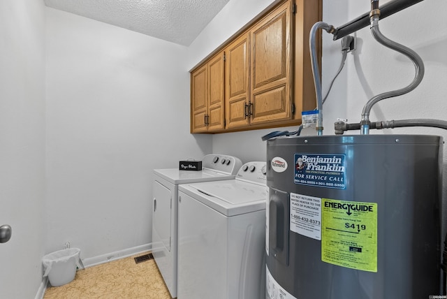 laundry area with cabinet space, baseboards, washer and clothes dryer, electric water heater, and a textured ceiling