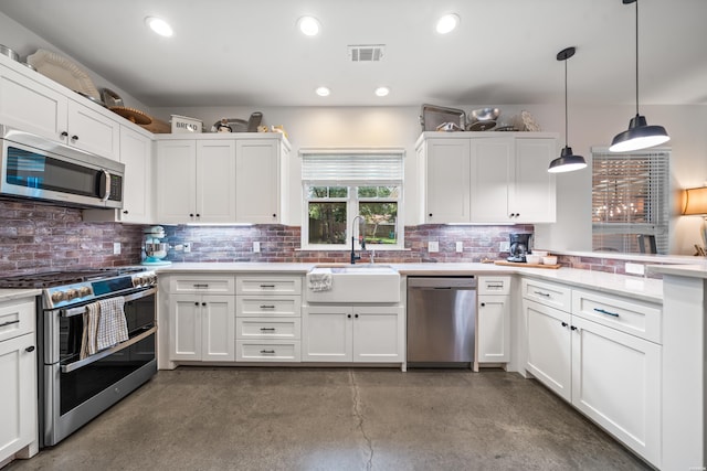 109 Spencer Chase Ct, Hot Springs, AR 71901 - kitchen with appliances with stainless steel finishes, a peninsula, concrete floors, white cabinetry, and decorative backsplash