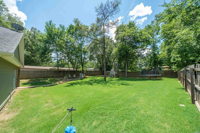 109 Spencer Chase Ct, Hot Springs, AR 71901 - fenced backyard with a trampoline and a playground