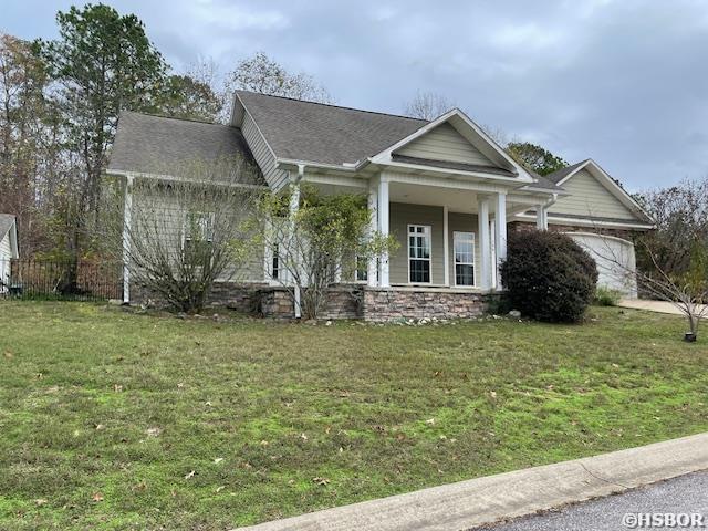 view of front of home with a front lawn and an attached garage