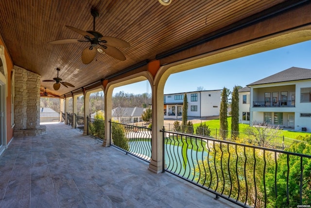 view of patio / terrace featuring a residential view, ceiling fan, and fence