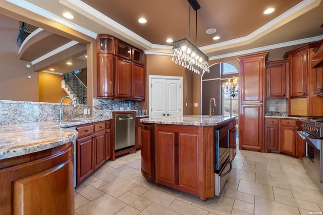 kitchen with a sink, a raised ceiling, light stone countertops, and stainless steel appliances