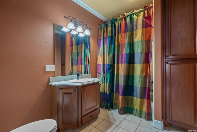 bathroom with tile patterned flooring, crown molding, toilet, and vanity