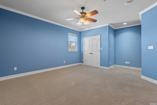 unfurnished room with ceiling fan, light carpet, baseboards, and ornamental molding