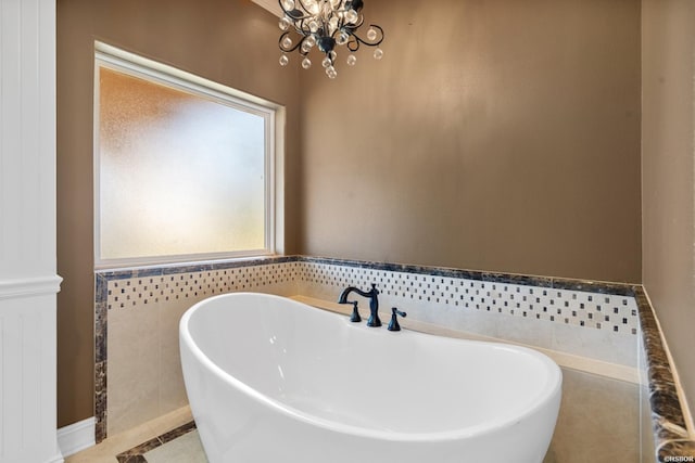 full bath with a notable chandelier and a soaking tub