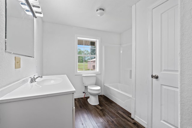 bathroom featuring toilet, shower / washtub combination, wood finished floors, and vanity