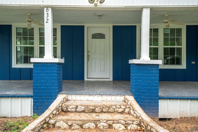 doorway to property with board and batten siding and a ceiling fan