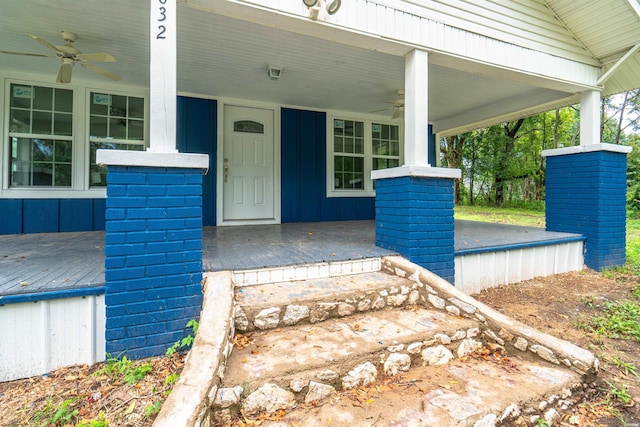 property entrance featuring a porch, board and batten siding, and a ceiling fan