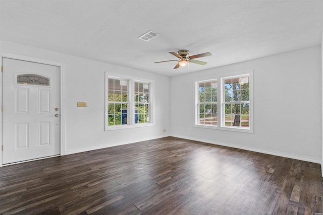 interior space featuring dark wood-type flooring, visible vents, and baseboards