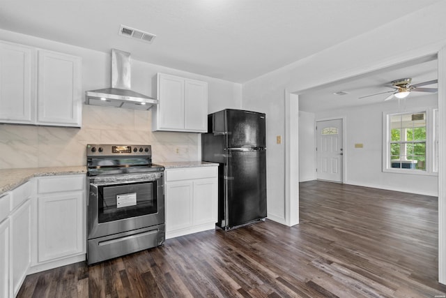 kitchen featuring visible vents, white cabinets, freestanding refrigerator, stainless steel electric range, and exhaust hood