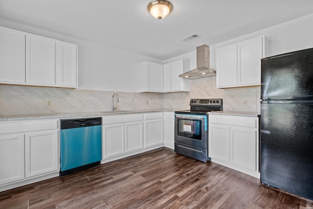 kitchen featuring wall chimney range hood, appliances with stainless steel finishes, white cabinets, and a sink