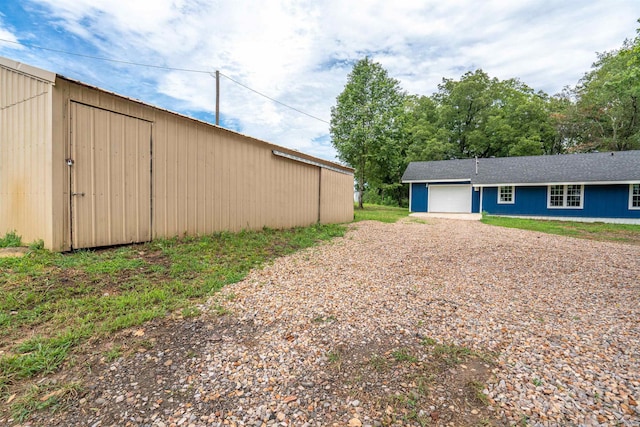 exterior space with driveway and an attached garage