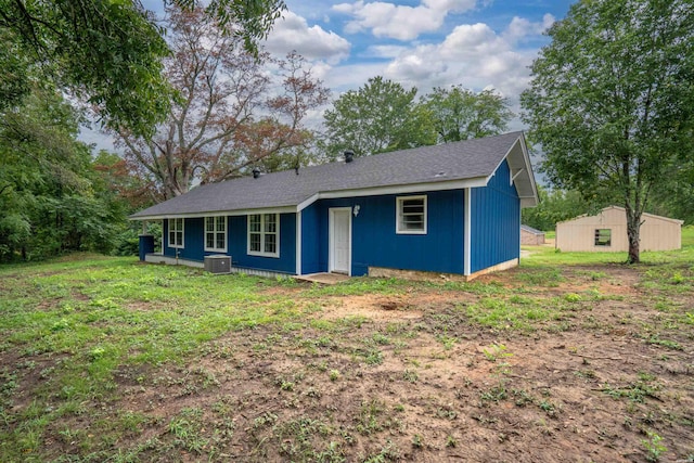 ranch-style house with central AC and an outbuilding