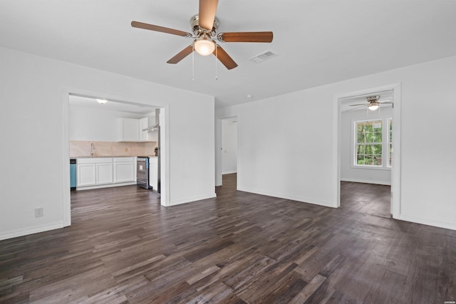 unfurnished living room with baseboards, visible vents, dark wood finished floors, and a sink