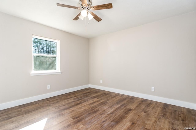 spare room with a ceiling fan, baseboards, and wood finished floors